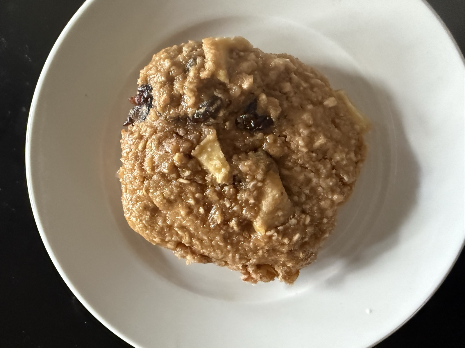 Apple-oat protein breakfast cookie on a white plate