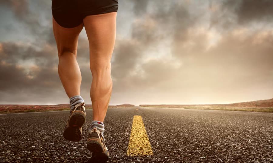Runner on an open road at dawn